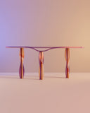 Sculptural console table with a handcrafted glass top and artistic base. A designer statement piece for contemporary interiors.
