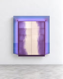 Contemporary Costa cabinet featuring a reflective iridescent purple finish, layered rectangular framing, and a minimalist box-shaped silhouette. The luminous surface and bold geometry create a sculptural statement piece for contemporary interiors.