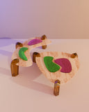 Luxury low table with organic forms and coloured stone detailing. Designed as a statement piece for contemporary interiors.