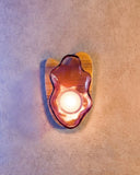 Sculptural wall lamp featuring handcrafted glass and organic contours. A designer lighting piece inspired by natural pearl formations.