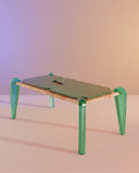 Sculptural dining table featuring a handcrafted stone top and coloured glass legs. A designer table inspired by oceanic tones and forms.