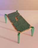 Contemporary designer table with sculptural coloured glass supports. Crafted to showcase material innovation and artistry.