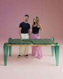 Sculptural stone dining table with handcrafted glass elements. A luxury furniture piece for sophisticated dining spaces.
