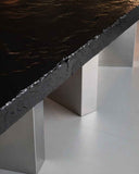 Modern black concrete table with silver legs on a white floor. BLACK MOON | Modern Contemporary Table | Limited Edition