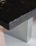 Angled view of the Black Moon sculptural dining table by Alex Turco highlighting its contemporary silhouette