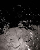 Close-up of a textured surface with a dark background. BLACK MOON | Modern Contemporary Table | Limited Edition