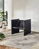Sculptural chair crafted from Nero Marquina marble. A designer seating piece showcasing bold natural stone veining.