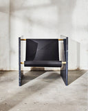 Contemporary stone chair crafted from Nero Marquina marble. A collectible furniture piece with sculptural character