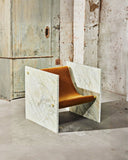 Contemporary stone chair showcasing unique Pistache marble textures. Crafted for sophisticated residential spaces.