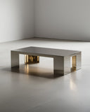 Sculptural coffee table featuring a stone top and polished metal base. A designer coffee table crafted for contemporary luxury interiors.