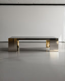 Luxury stone coffee table with a monolithic profile and metal accents. Designed for sophisticated contemporary interiors.
