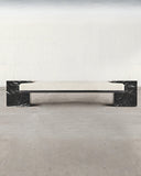 Sculptural bench crafted from Nero Marquina marble. A designer stone bench showcasing dramatic natural veining and contemporary design.