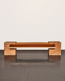Sculptural bench crafted from orange travertine stone. A designer bench celebrating natural texture and contemporary craftsmanship.
