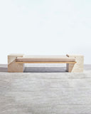 Sculptural bench crafted from natural travertine stone. A designer seating piece showcasing timeless materiality and contemporary design.