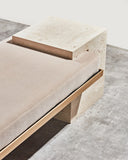 Designer bench crafted from solid travertine stone. Created as a functional work of art for luxury spaces.