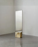 Sculptural wall mirror framed in natural onyx stone. A designer mirror celebrating the beauty of translucent stone.