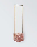 Sculptural wall mirror framed in natural red jasper stone. A designer mirror showcasing rich colour and natural texture.