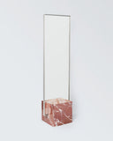Luxury stone mirror featuring a contemporary architectural silhouette. Designed as a statement piece for modern interiors.