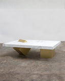 Coexist coffee table featuring a white marble top with sculptural brass geometric legs. A statement designer coffee table for contemporary luxury interiors.