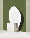 Sculptural mirror combining reflective surfaces and Calacatta marble. Designed to create depth and visual impact in interiors.