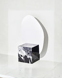 Sculptural floor mirror framed in Grand Antique marble. A designer mirror showcasing dramatic natural stone veining.