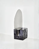 Sculptural marble mirror highlighting bold natural stone patterns. Crafted to combine functionality and collectible design.
