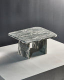 Contemporary glass coffee table featuring sculptural stone supports. Designed as a statement piece for luxury interiors.