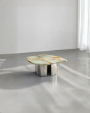 Sculptural centre table with a rounded stone profile. A collectible furniture piece for contemporary interiors.
