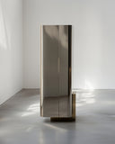Contemporary designer armoire with polished metal surfaces. Crafted to combine functionality and sculptural design.