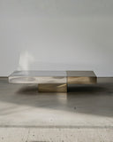 Designer coffee table featuring a stone surface and metal pedestal base. Crafted to balance elegance and functionality.