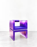 Adrian Cruz Quantum Armchair featuring a bold geometric silhouette in glossy purple, with a squared backrest, open frame, and angular seat supports. Its vivid monochromatic finish and architectural construction give this contemporary accent chair a distinctly sculptural character.