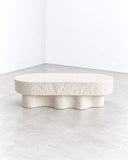 Alentes Atelier Medusa Bench featuring a generously padded, rounded rectangular seat above a sculptural base with flowing, wave-like contours. Its monochromatic ivory finish and organic silhouette combine tactile softness with contemporary design.