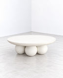 Alentes Atelier Piedi Coffee Table featuring a smooth, oval tabletop supported by a cluster of rounded spherical legs in a warm ivory finish. Its playful geometric base and low sculptural profile create a distinctive centrepiece for contemporary living spaces.