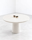 Alentes Atelier Poise Table Sculpted featuring a round tabletop with a finely textured surface and a substantial cylindrical pedestal base. Its softly rounded proportions and sculptural finish bring understated elegance to contemporary interiors.