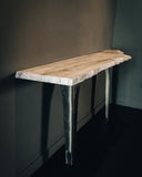 Designer console table showcasing sculptural proportions and premium materials. Crafted to elevate modern living spaces.
