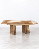 Alex Turco Aurisino Coffee Table featuring an irregular, naturally patterned stone-look top and substantial angular pedestal legs. Its earthy tones and sculptural geometry bring an organic, contemporary statement to luxury living spaces.