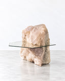 Alex Turco Cristallo Side Table featuring a sculptural, natural crystal-like stone base paired with a transparent glass tabletop. The contrast between the raw, textured formation and the clean glass surface creates a distinctive contemporary accent.