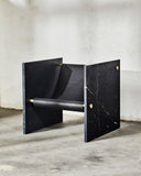 ADRI designer chair in Nero featuring a dark sculptural seat and architectural side panels. A statement chair for contemporary luxury interiors.