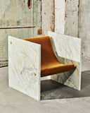 ADRI designer chair in Pistache featuring a soft green sculptural seat and architectural side panels. A contemporary statement chair for sophisticated interiors.