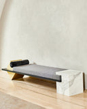 Sculptural Coexist daybed with a light stone frame and upholstered cushion in Statuary. A statement designer daybed for modern luxury spaces.