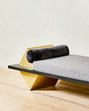 Coexist Statuary designer daybed showcasing rounded stone supports and a sculptural upholstered seat. Crafted as a distinctive lounge piece for contemporary interiors.