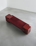 Arielle Assouline Coexist bench in Oxblood with a long sculptural seat and rounded end supports. A contemporary designer bench for sophisticated residential and hospitality spaces.
