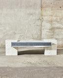 Coexist Carrara designer bench featuring a sculptural marble frame and contemporary geometric form. A statement stone bench for luxury modern interiors.