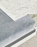 Sculptural Carrara marble bench featuring geometric supports and a refined contemporary profile. Designed to bring natural stone character to luxury interiors.