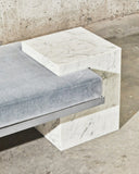 Close-up of the Coexist Carrara bench highlighting its sculptural marble construction and natural stone veining. A statement designer bench for sophisticated modern interiors.
