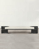 Sculptural bench crafted from Nero Marquina marble. A designer stone bench showcasing dramatic natural veining and contemporary design.
