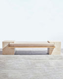 Sculptural travertine seating with a refined monolithic profile. A collectible design piece for contemporary interiors.