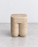 ETAMORPH Chunky Stool in travertine features a softly rounded rectangular seat and two chunky cylindrical supports in warm beige stone. Its tactile surface and bold, minimal silhouette bring natural material character to contemporary interiors.