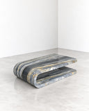 ETAMORPH Fold Coffee Table Special Edition features a low, layered silhouette with curved, folded-looking forms in blue-grey stone with expressive natural veining. Its sculptural geometry and distinctive material pattern create a striking centrepiece for contemporary living spaces.
