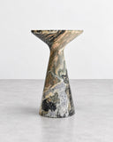 ETAMORPH Pawn Side Table featuring an hourglass-shaped pedestal and flared tabletop carved from richly patterned multicoloured stone. Its expressive veining and sculptural profile make it a statement accent for sophisticated contemporary interiors.